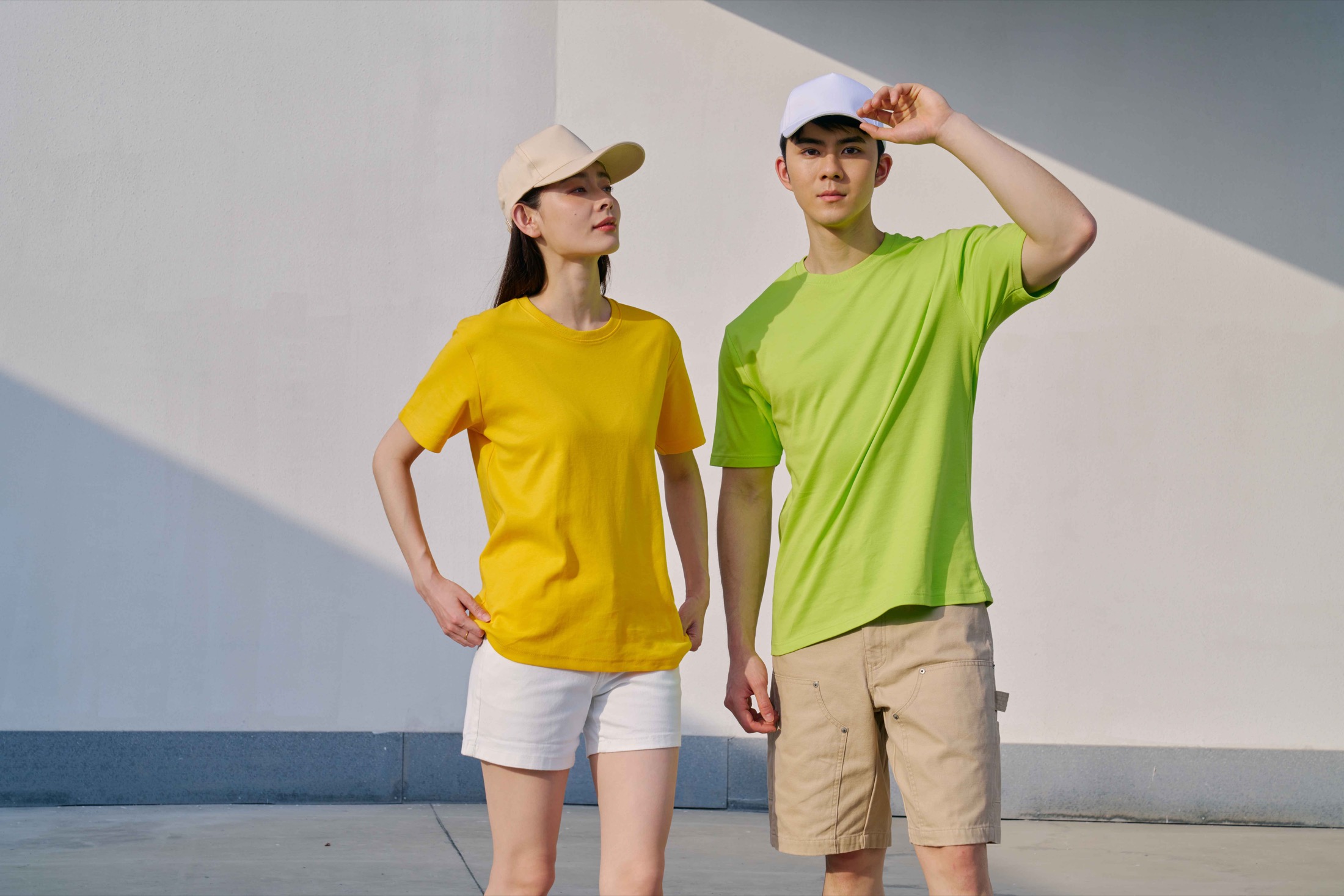 Models showing the fit of yellow and lime green RC06 cotton interlock T-shirts