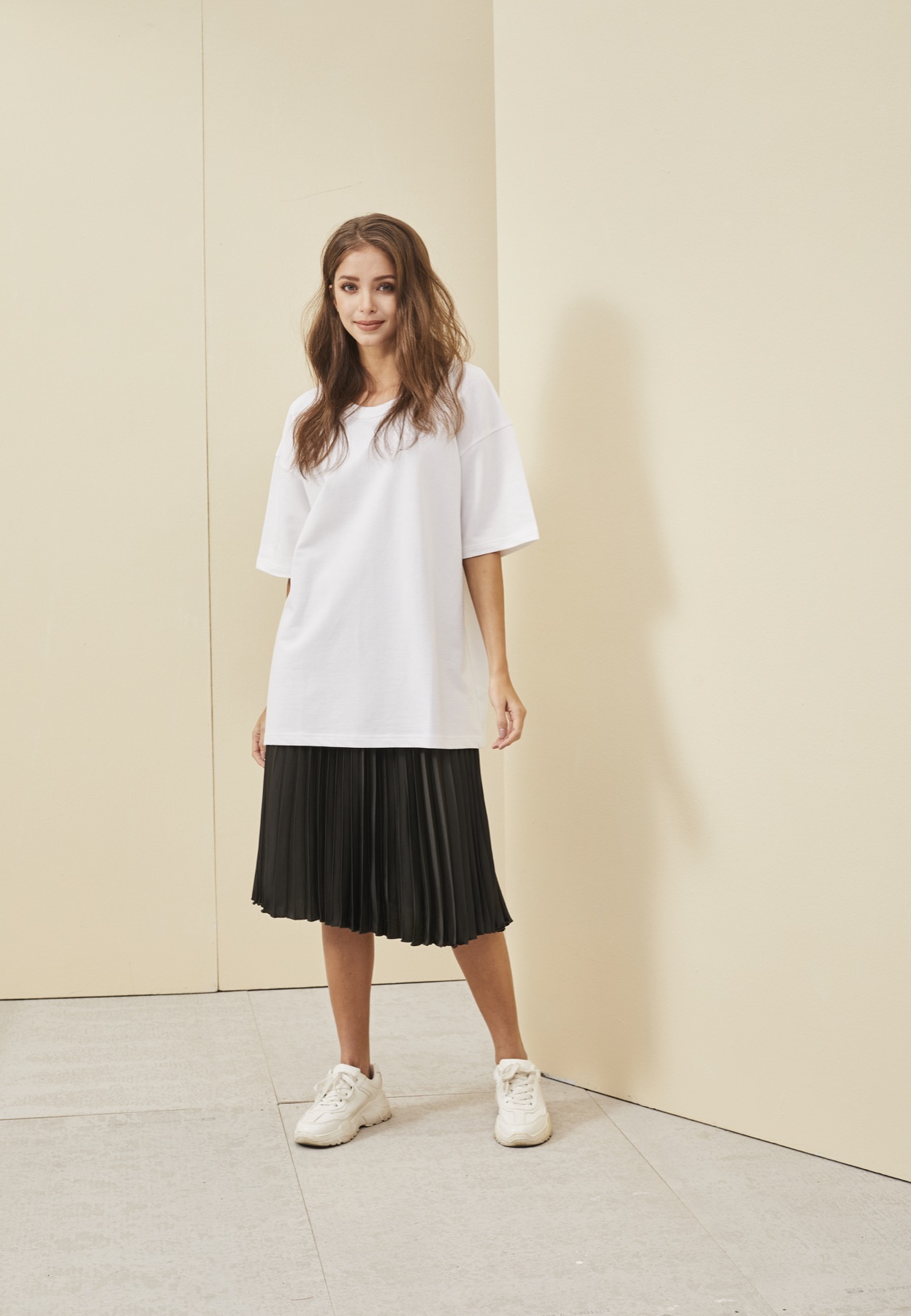 Model wearing a white RC08 oversized French terry T-shirt